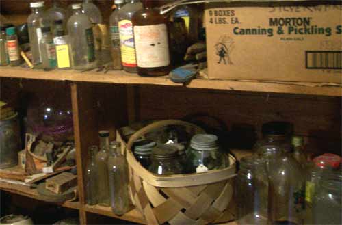 Attic shelves are full of jars and old bottles