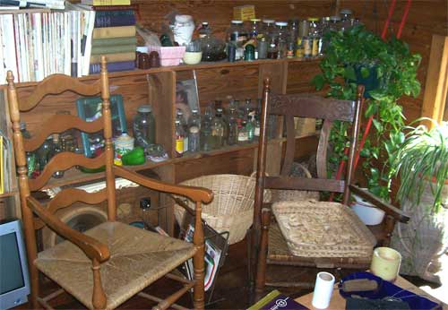 old chairs, bottles, and magazines in the attic