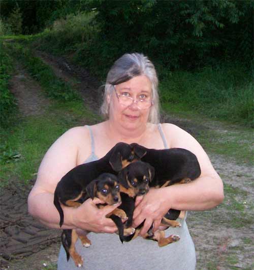 Jan holds a bunch of puppies